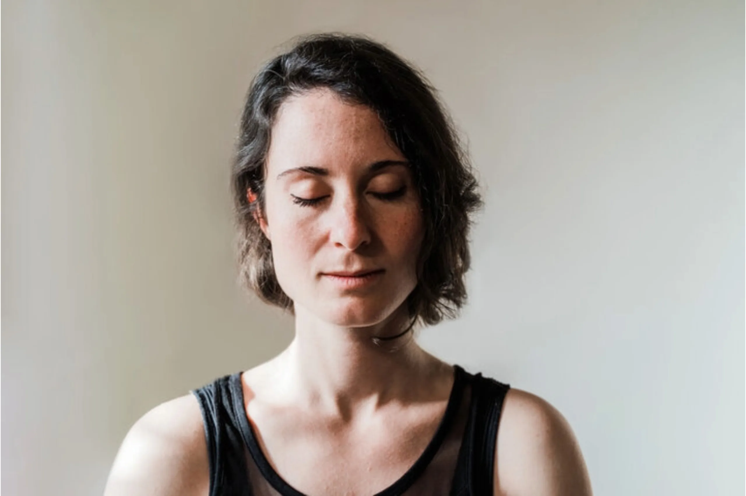 a woman meditating calmly